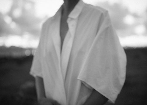 Fotografia íntima a preto e branco de torso com camisa