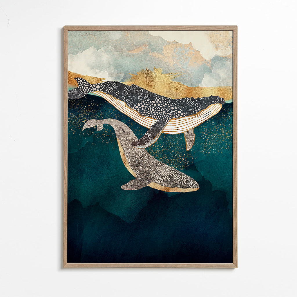 Quadro baleias douradas sobre mar azul profundo